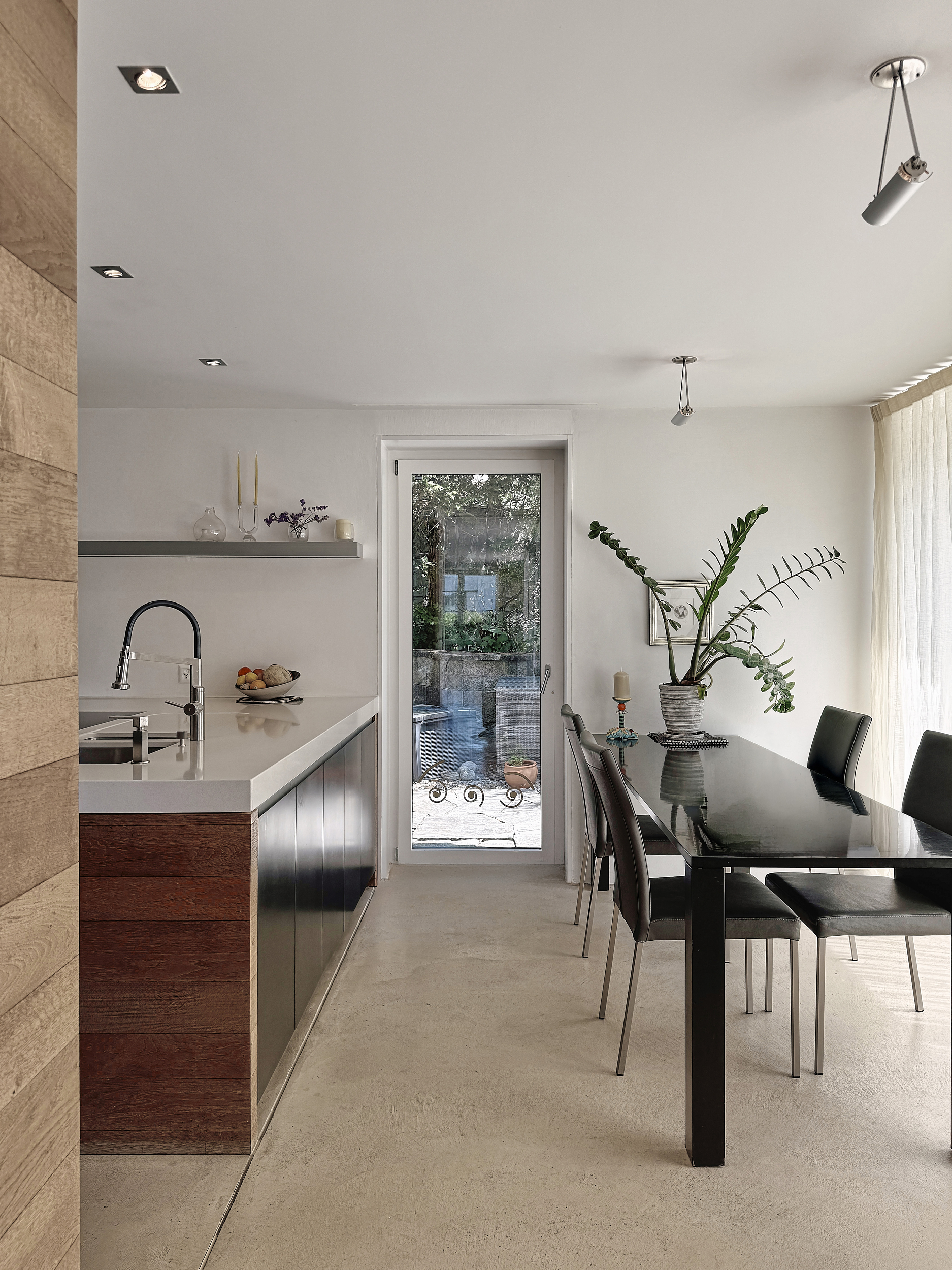 Modern, bright kitchen with wooden finish and breakfast/lunch area.
